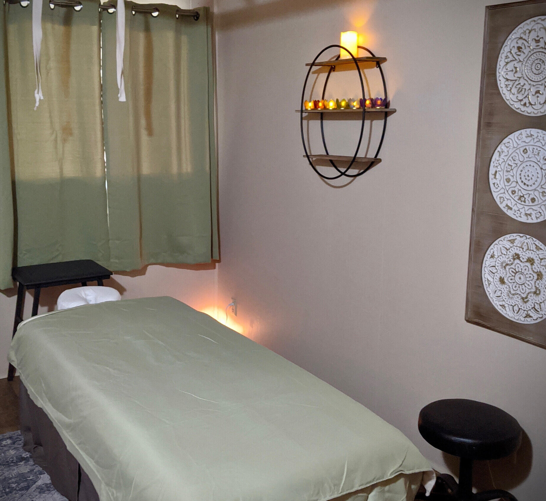 A photo inside the massage studio of a massage table